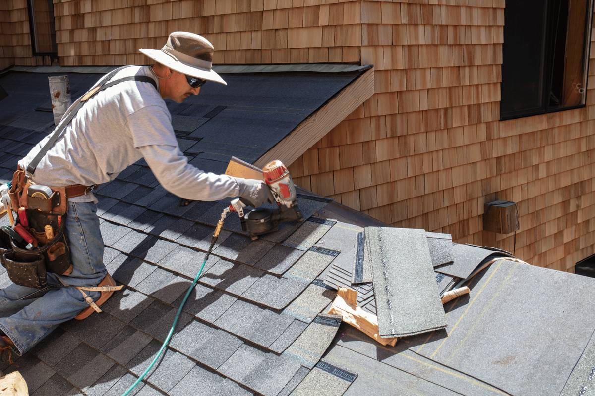 Close-up of careful roofing craftsmanship with textured shingles and precise handwork
